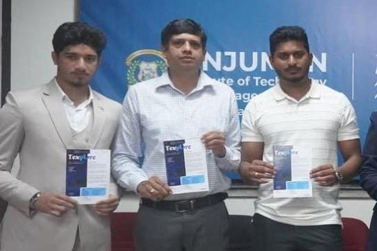 Three people holding copies of the Texplore magazine