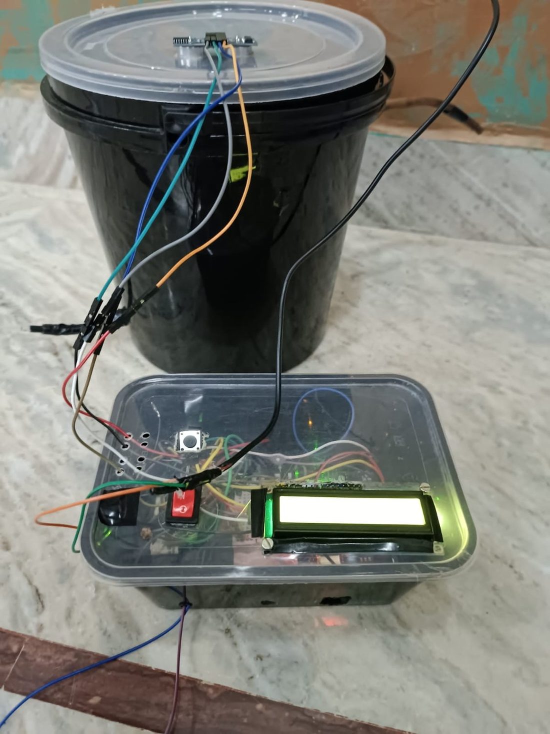 The finished build. Sensor above the water, electronics clear of the overflow path.